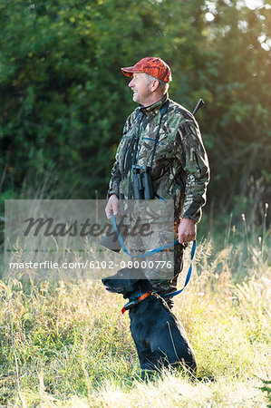 Man hunting with dog