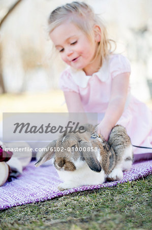 Girl playing with rabbit pet