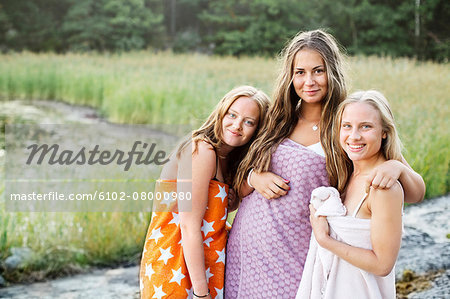 Smiling teenage girls wrapped in towels