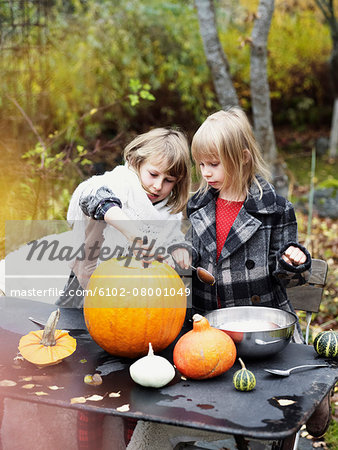 Girls preparing pumpkin