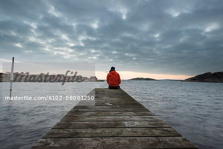Man on jetty looking at view Man on jetty looking at view