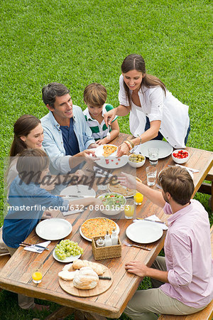 Family and friends having picnic while on vacation
