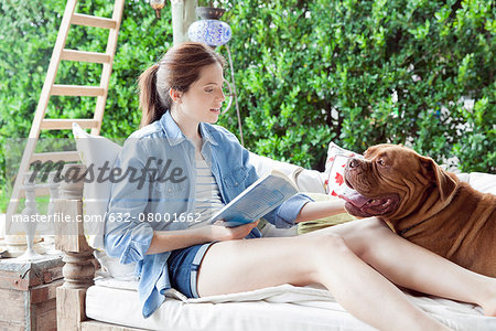 Young woman relaxing outdoors with dog