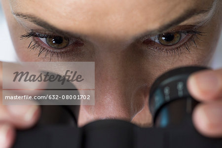 Scientist using microscope, close-up