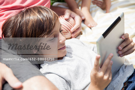 Boy using digital tablet outdoors