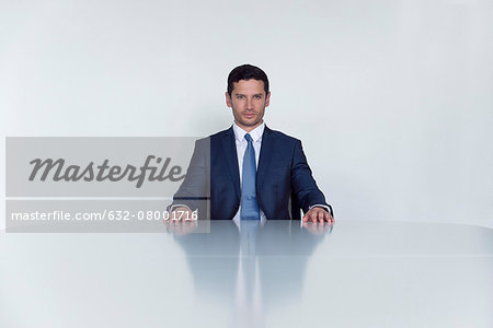 Businessman seated at table, portrait