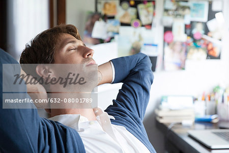 Man relaxing in home office