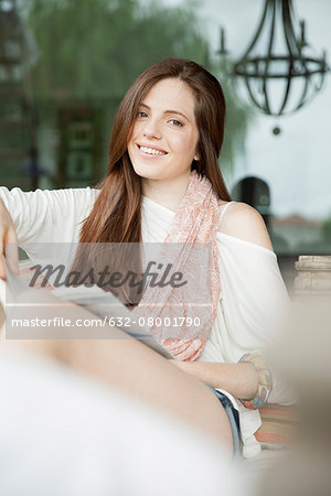 Young woman relaxing outdoors with book