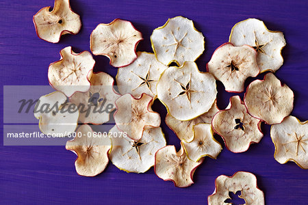 Apple Chips, dehyderated, studio shot on purple background