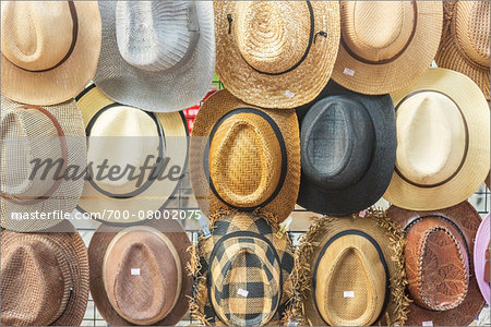 Straw hats for sale in a local street market in Bangkok, Thailand