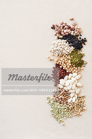 Piles of Dried Beans and Legumes, studio shot on beige background