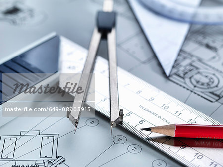 Drawing equipment sitting on engineering drawing
