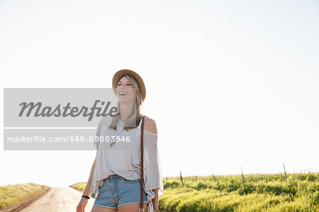 Mid adult woman on country road, laughing