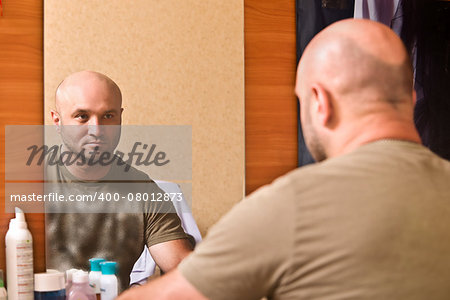 Man combs wig. Beauty salon, dressing room.