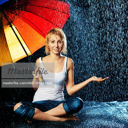 beautiful girl with umbrella under rain, black background