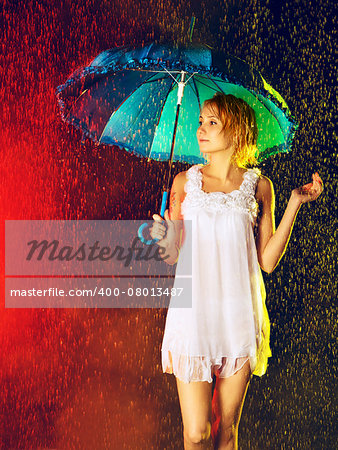 beautiful girl with umbrella under rain, black background