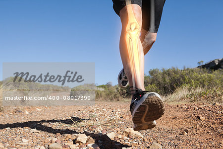 Digital composite of Highlighted leg bones of jogging man