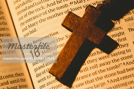 Open bible and wooden cross overhead shot