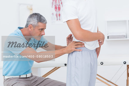 Doctor examining his patient back in medical office