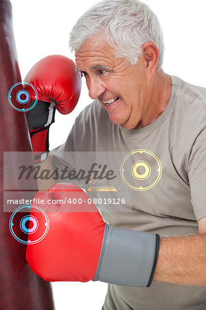 Portrait of a determined senior boxer against fitness interface