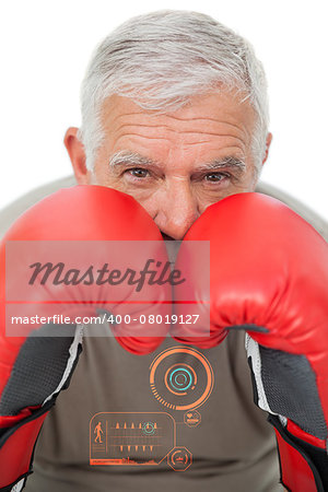 Close-up portrait of a determined senior boxer against fitness interface