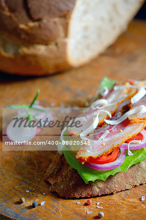 Fresh sandwiches with ham and vegetables on old wood