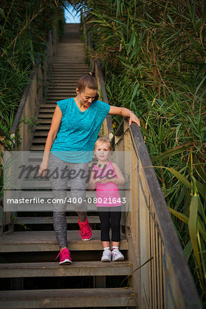 Healthy mother and baby girl outdoors in the evening