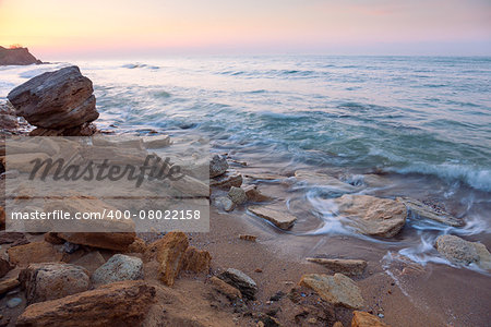 beautiful sunrise landscape,  the rocky sea coast and water waves