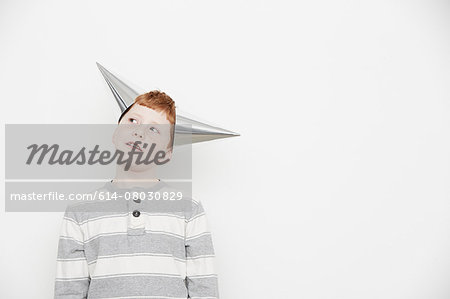 Boy wearing two cone party hats