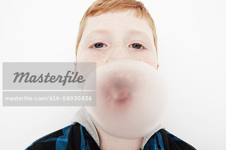 Boy blowing bubble gum