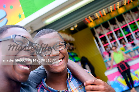Portrait of teenage boys laughing at amusement park