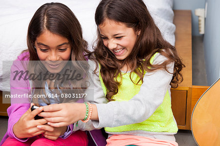 Three girls using smartphone