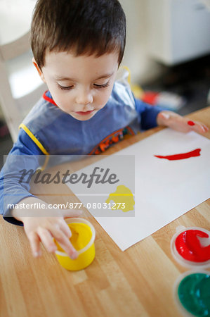 A boy finger painting