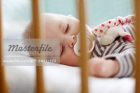 Baby boy slipping in his crib