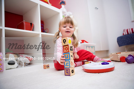 Baby girl playing in her room