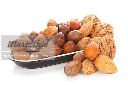 Various nuts, walnuts, hazelnuts, almond and chestnuts in black bowl isolated on white background. Seasonal healthy nuts.