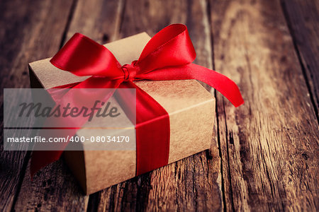 Gift box with a red ribbon on a wooden background, Valentines Day