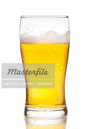 glass of fresh beer with drops on white background, with reflection on table