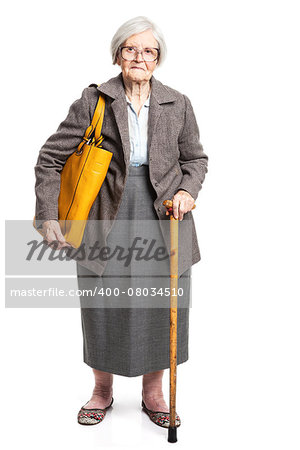 Elegant senior woman with walking stick standing over white