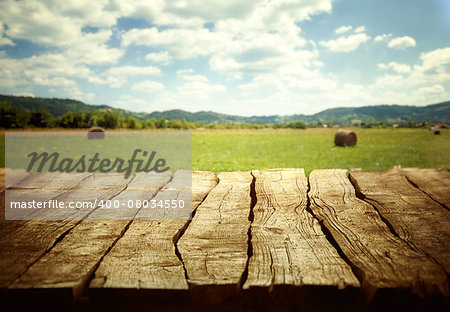 Wooden empty table. Wooden display with spring fields bokeh.