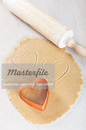 rolled dough with heart-shaped cookie cutter and rolling pin, valentine's day concept