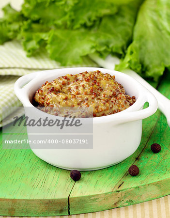 Traditional sauce dijon mustard on a wooden table