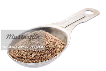 gluten free teff flour on an old aluminum measuring spoon isolated with a clipping path