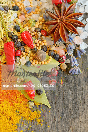 Colorful spices and herbs on old wood