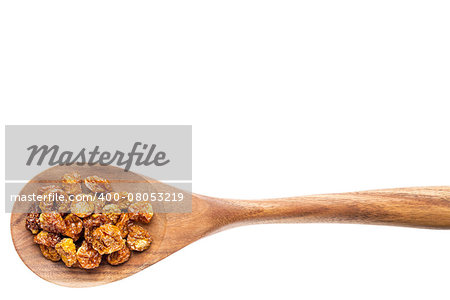 dried goldenberries on a wooden spoon isolated on white with a clipping path