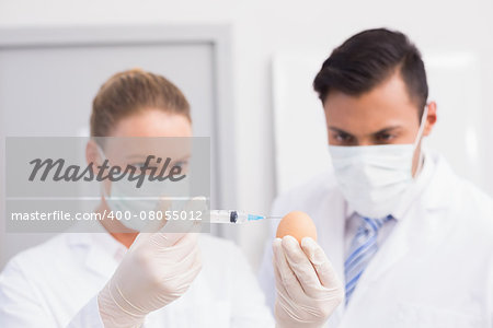 Scientists injecting an egg in the laboratory