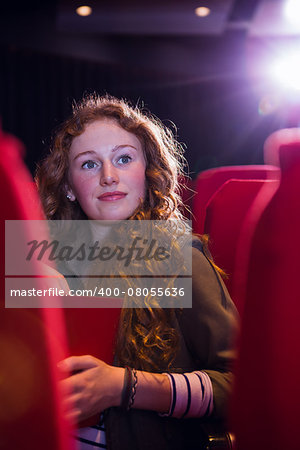 Young woman watching a film at the cinema