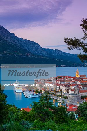 Elevated view over Korcula's picturesque Stari Grad (Old Town) illuminated at dusk, Korcula Town, Korcula, Dalmatia, Croatia, Europe