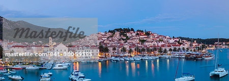 Elevated view over the picturesque harbour town of Hvar illuminated at dusk, Hvar, Dalmatia, Croatia, Europe