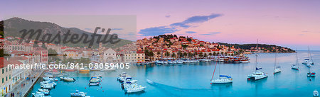 Elevated view over the picturesque harbour town of Hvar illuminated at dusk, Hvar, Dalmatia, Croatia, Europe Elevated view over the picturesque harbour town of Hvar illuminated at dusk, Hvar, Dalmatia, Croatia, Europe